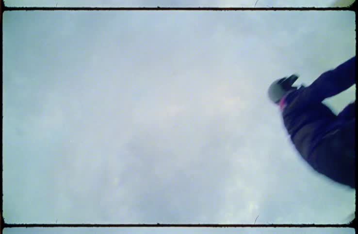 A film strip of a person on a motorbike that rides by and then puts their hand over the camera lens