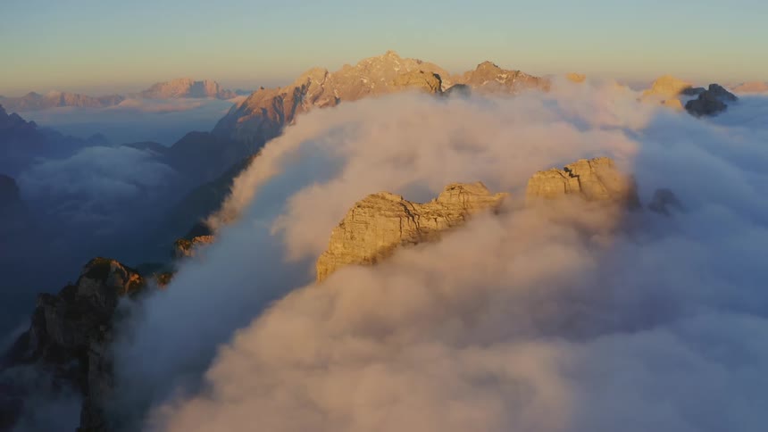 The tall mountains reach up past the clouds