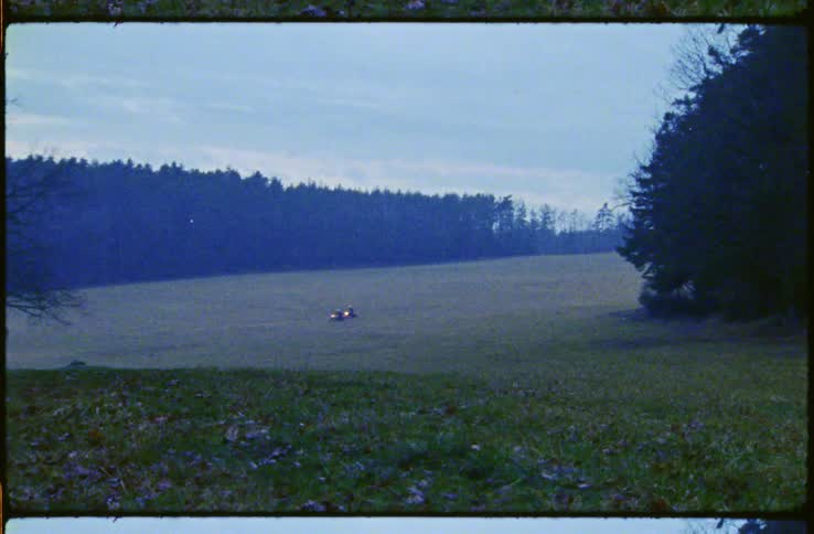 Two motorcycles driving on country road at dusk