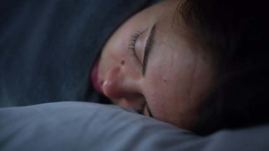 A woman is sleeping indoors
