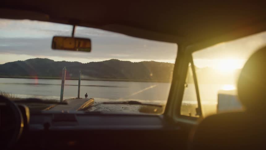 The sun is rising on the water