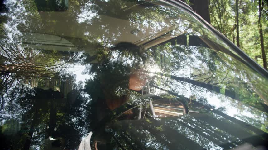 A woman gets into the drivers seat of a vehicle