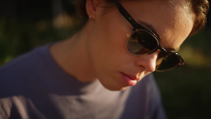 A teenage girl outside with sunglasses on