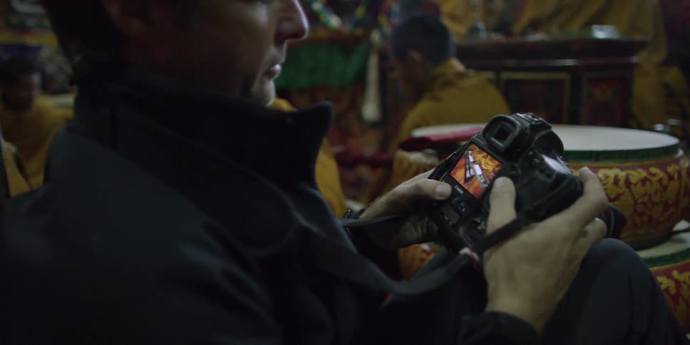 Man looking at pictures that were taken on a camera