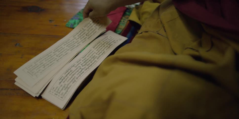 Person flips a small piece of paper with writing on it