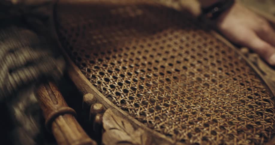 A carpenter staining a chair