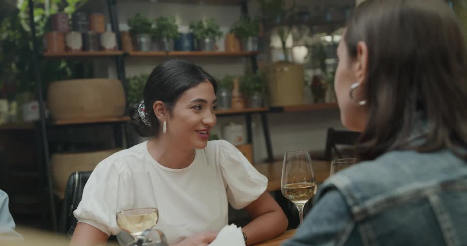 Women sitting at a table talking and laughing