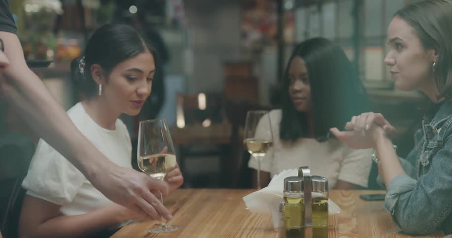 People are talking and being served drinks in the restaurant