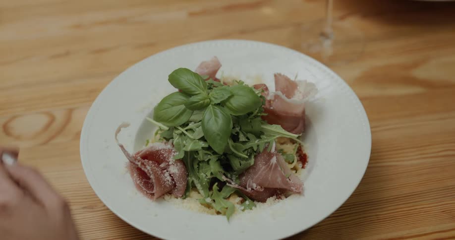 A plate of food being placed in front of a customer in a restaurant