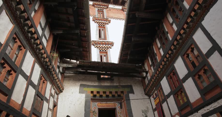 A photographer walks toward the stairs of a temple building
