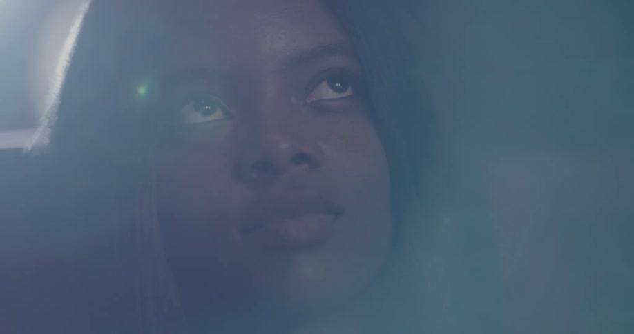A woman looking off into the distance and blinking