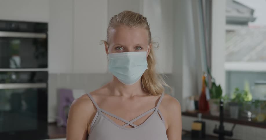 A woman is wearing a face mask indoors