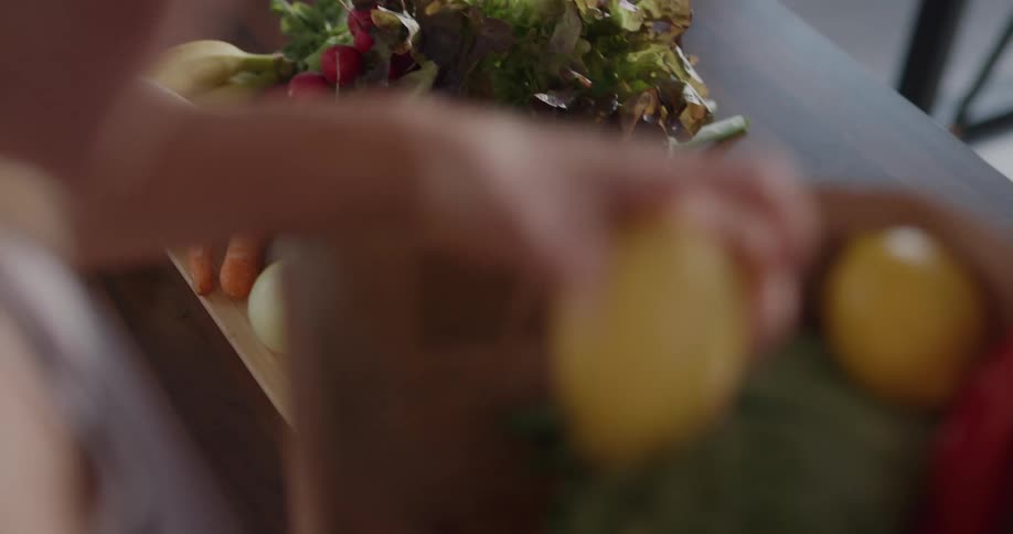 A young woman unpacks a bag of groceries at home