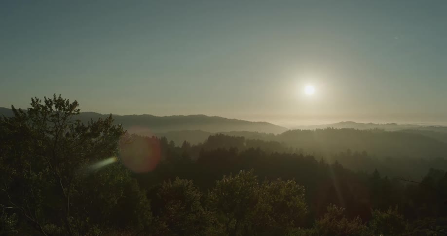 The sun shining over a landscape view in nature