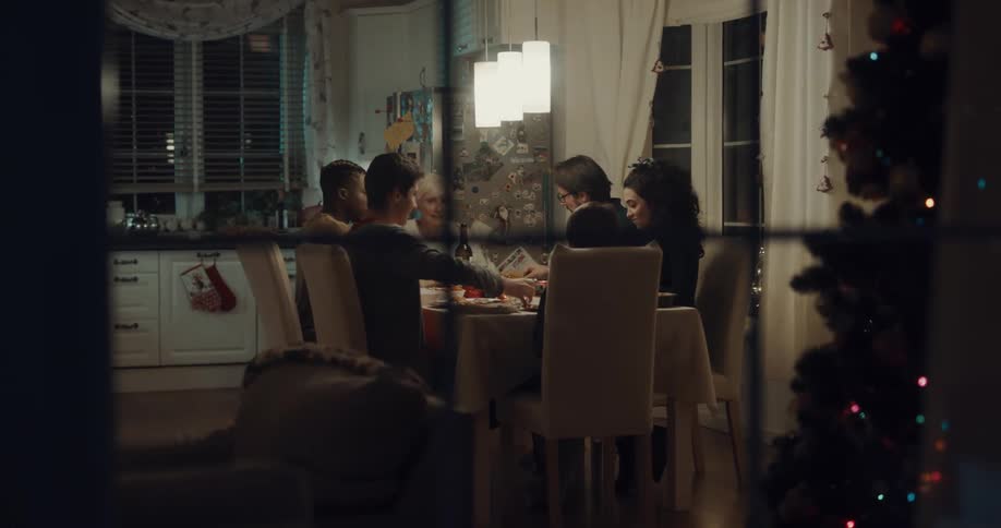 Family and friends share christmas dinner laughing and talking