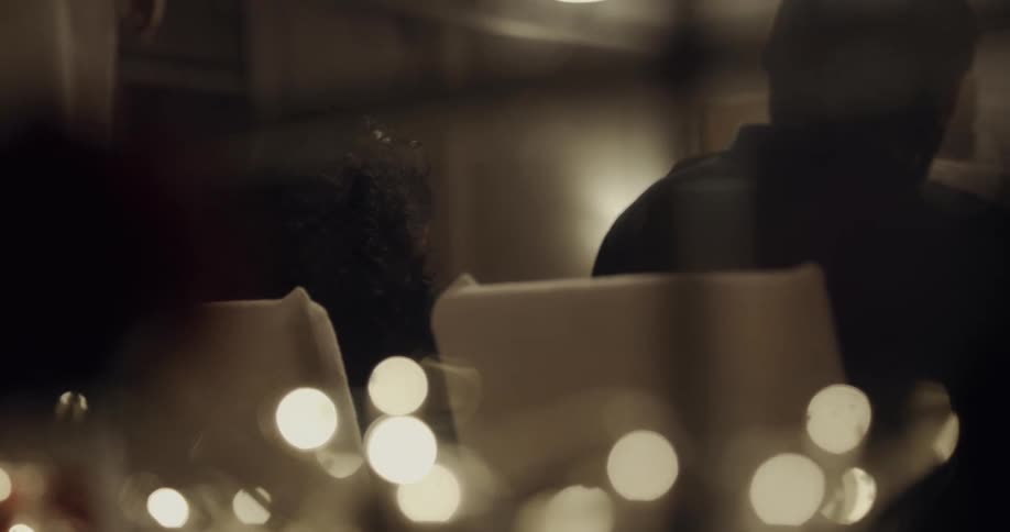 People sitting at a dinner table talking and eating