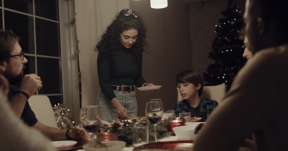 A woman serves pie at the dinner table