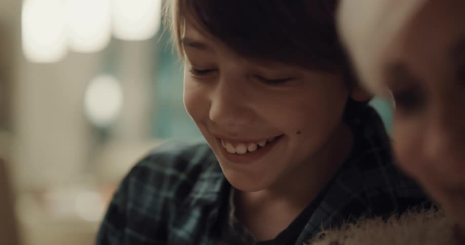 A young boy talks and laughs with his grandmother