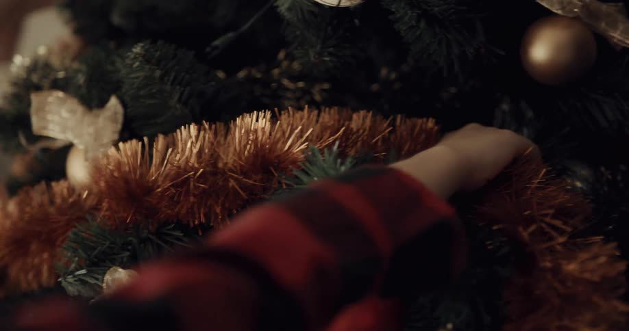 A mother and her son decorating a christmas tree