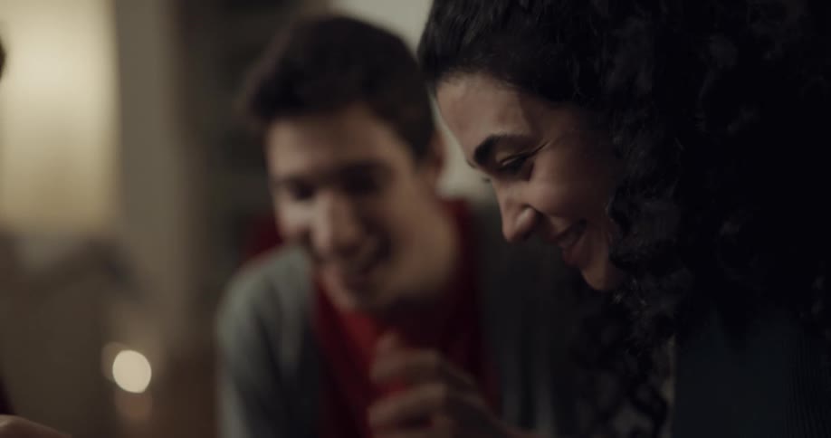 A man and a woman in a room talking and laughing
