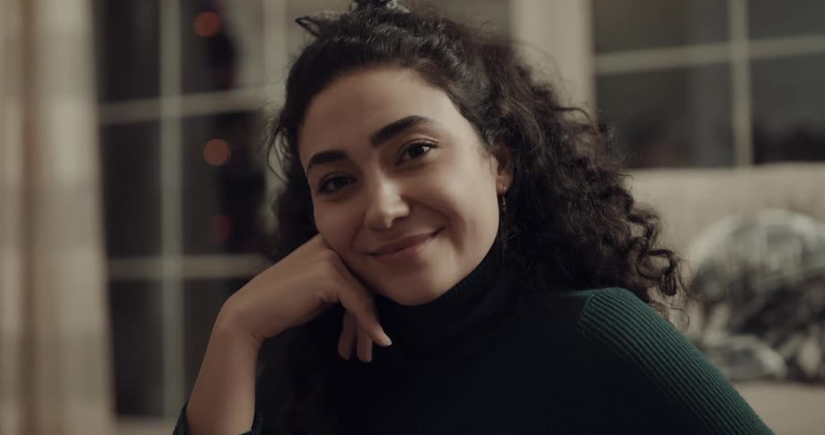 A woman is smiling indoors