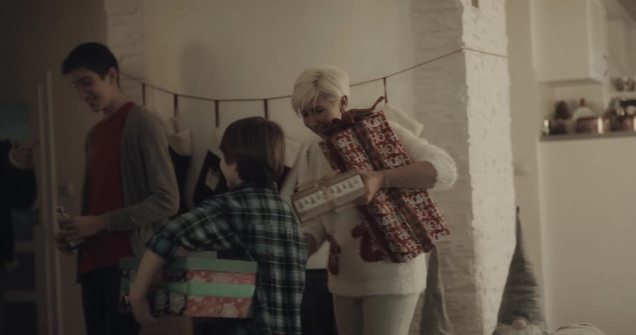 People hug and greet one another as they arrive at a home