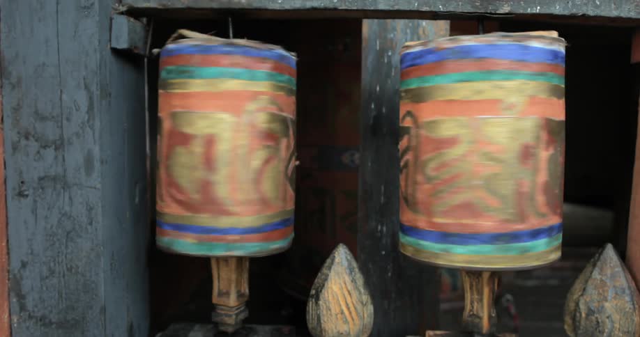 Cylindrical decorations spin on the exterior of a building