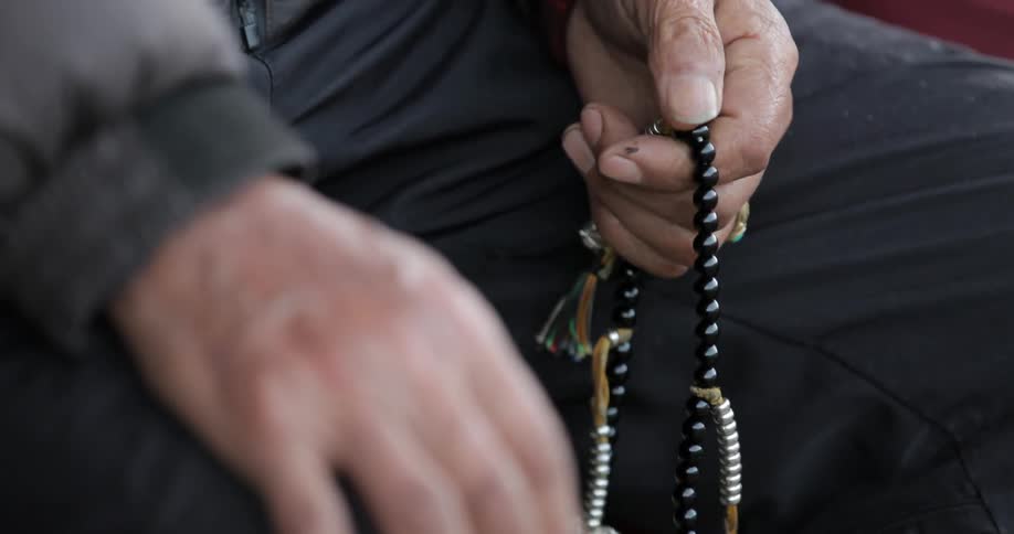 A man using prayer beads