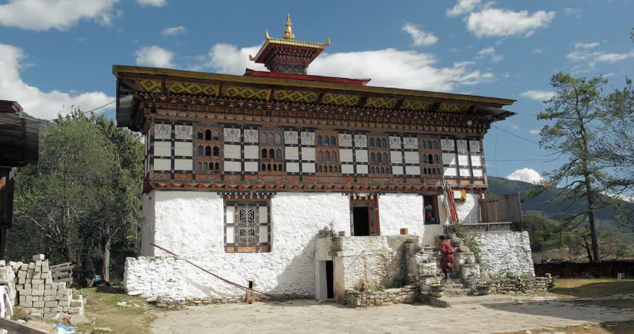 A person approaches a building with asian architecture