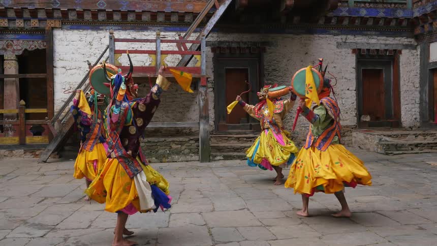 A group of people are dancing in a circle