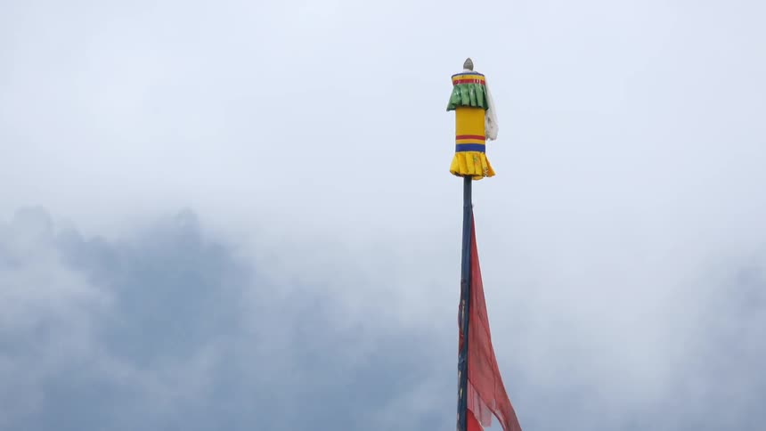 A flag on a pole flutters in the breeze