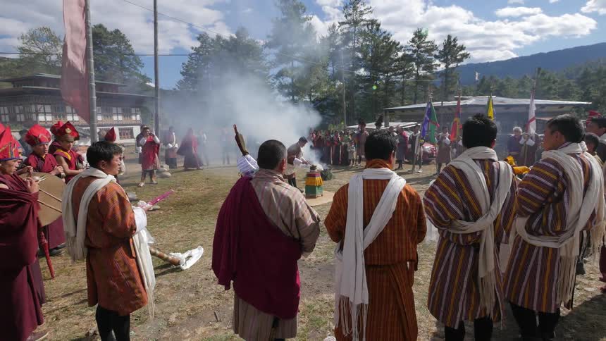 People gathered in a circle for a tibetan ceremony