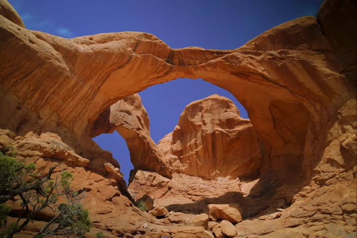 Timelapse of people hiking on a large rock formation
