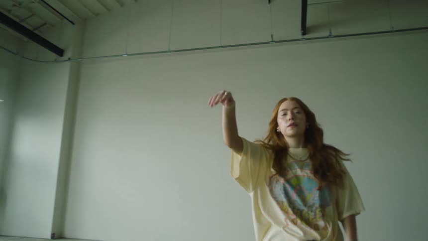 A woman is walking in an empty room