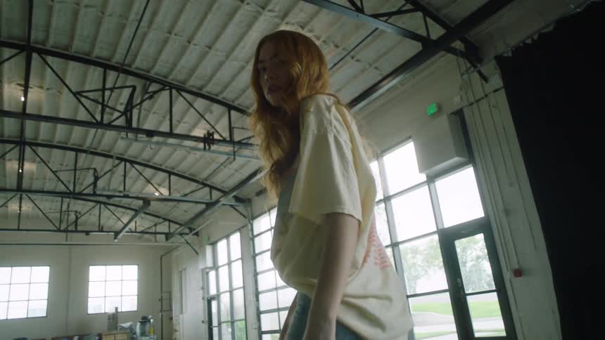 A woman is walking around a room during the day