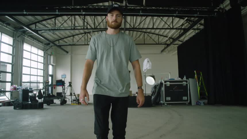 A man is standing in a room during the day