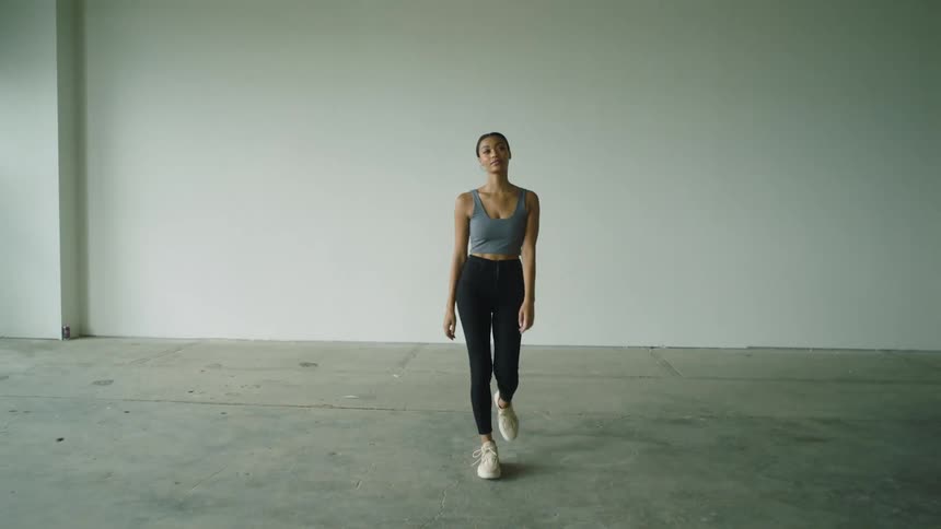 Female walking towards camera indoors for a photo shoot
