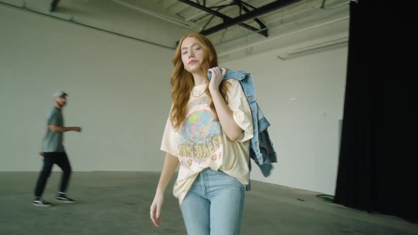 A man and woman walking in an empty warehouse