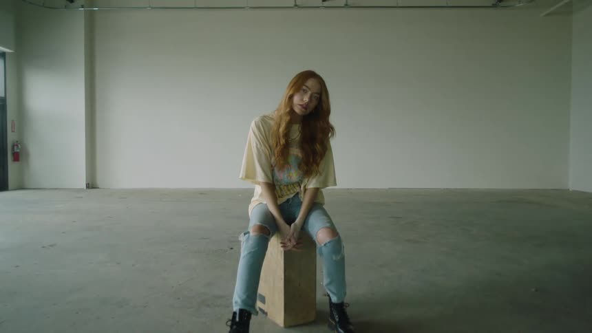 A woman is sitting in the room alone