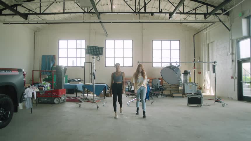 Two females walking together at a photoshoot