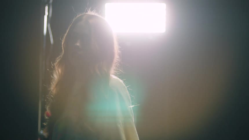 A woman is walking outdoors at night