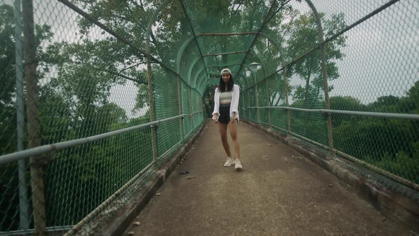 A woman is walking on a bridge in spring