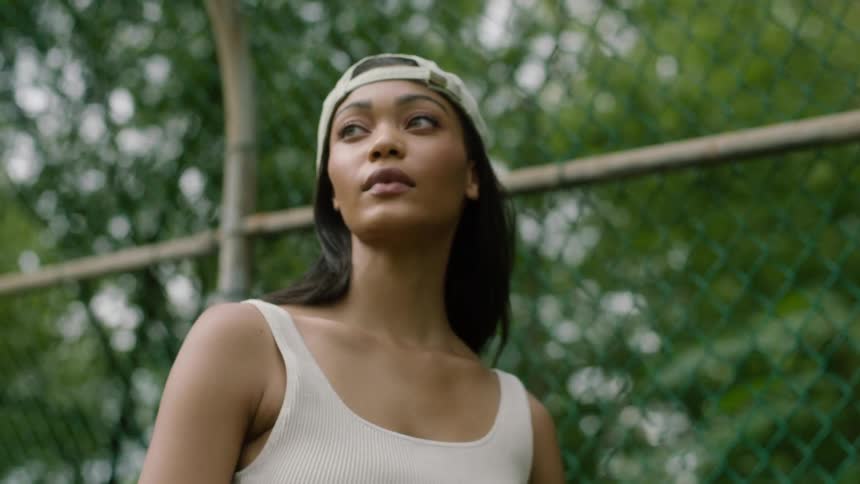 A black female standing outside near a fence