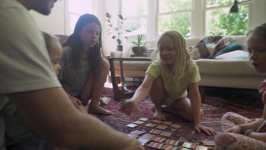 Family grouped around a board game playing together
