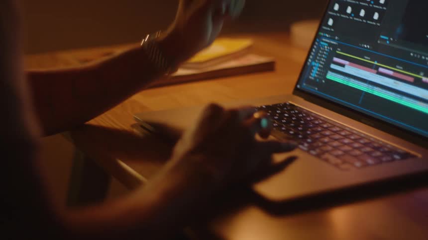 A person is typing on their laptop