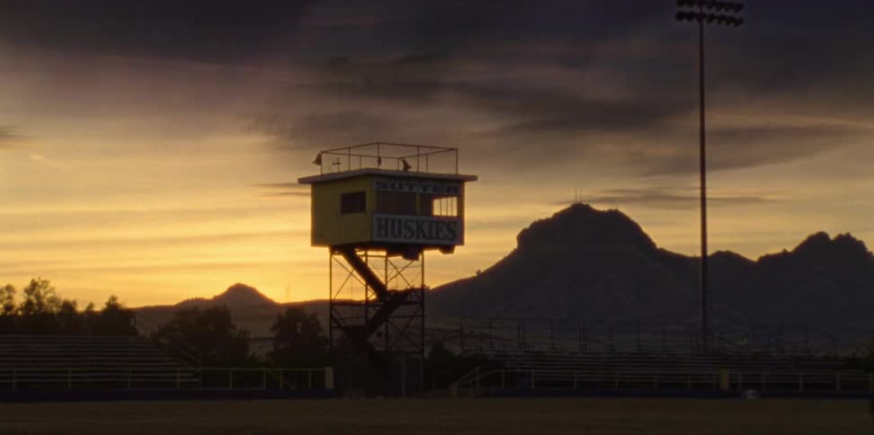 The sports broadcast booth for a small towns high school sits near mountains