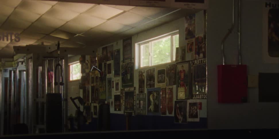 A camera zooms in on pictures on the wall of a gym