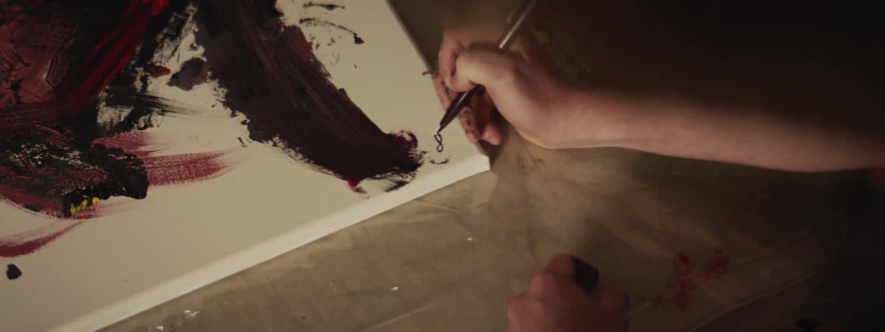 An artist signs his painting
