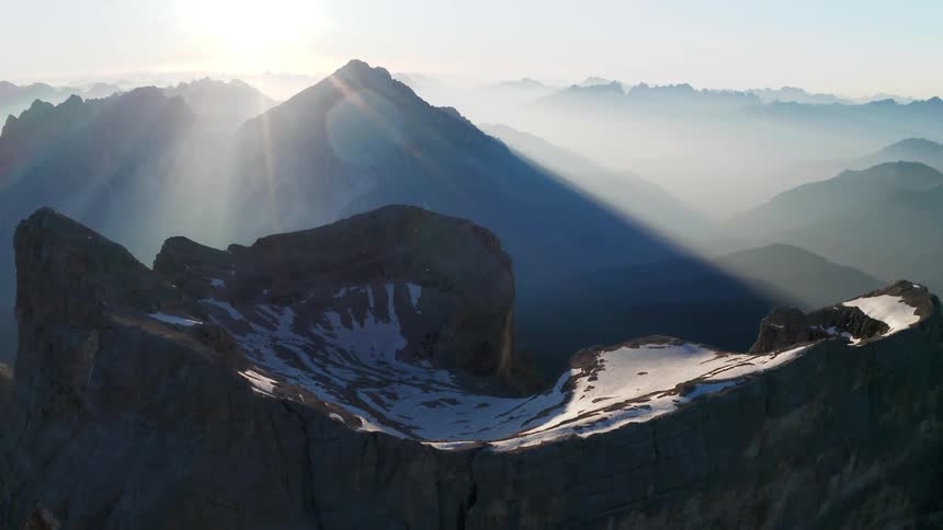 Sunlight shining over snowy mountains in nature on a winter day