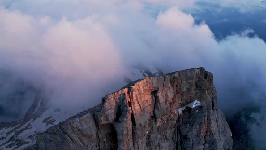 Aerial view of rugged mountains with clouds